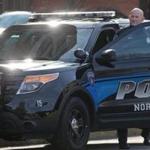 A Northeastern University officer stepped out of his police vehicle.