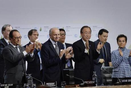 French President Francois Hollande, French Foreign Minister Laurent Fabius, United Nations Secretary General Ban Ki-moon and UN climate chief Christiana Figueres applauded during the climate conference Saturday.
