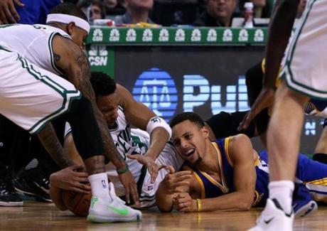 Boston, MA - 12/11/15 - (4th quarter) Boston Celtics guard Isaiah Thomas (4), Boston Celtics guard Evan Turner (11), and Golden State Warriors guard Stephen Curry (30) hit the parquet as they fight for a loose ball in the fourth quarter. The Boston Celtics take on the Golden State Warriors at TD Garden. - (Barry Chin/Globe Staff), Section: Sports, Reporter: Adam Himmelsbach, Topic: 12Celtics-Warriors, LOID: 8.2.752270934. 
