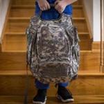 Nicholas Abreau posed for a portrait with the bullet resistant backpack his father Charles bought him in their home in Lowell, MA. 