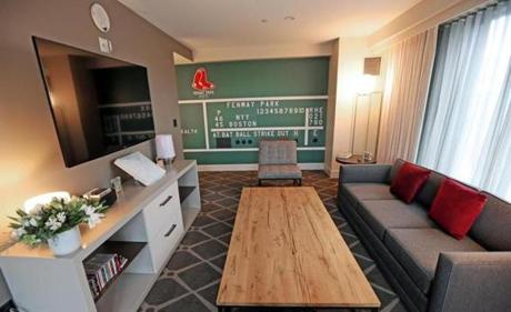 The 660-square-foot room features the #6 from the scoreboard, vintage baseball cards, and other Red Sox collectibles. 
