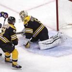 The Oilers? Andrej Sekera (left) slides the puck past Bruins goalie Jonas Gustavsson just 41 seconds into overtime.