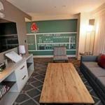 The 660-square-foot room features the #6 from the scoreboard, vintage baseball cards, and other Red Sox collectibles. 