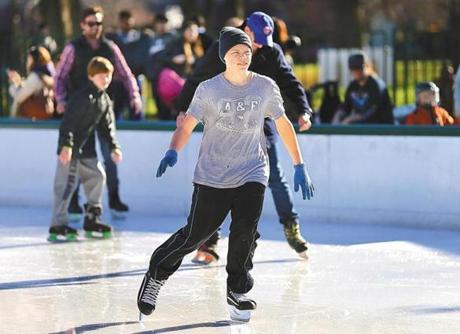 Boston-12/15/15 It was another warm december day as Johnathan Raschela, 16 wears a t-shirt as he skates on the Frog Pond on the Boston Cpommon. He was on a field trip with the Valley Collaborative School in Billerica. Boston Globe staff photo by John Tlumacki(metro)
