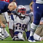 Patriots running back LeGarrette Blount grimaced as members of the training staff attend to him after he was injured Sunday night. 