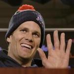 New England Patriots quarterback Tom Brady smiles and waves goodbye to the media after being asked by a reporter about his supposed friendship with Republican presidential hopeful Donald Trump at the NFL football team's facility Wednesday, Dec. 16, 2015, in Foxborough, Mass. (AP Photo/Stephan Savoia)