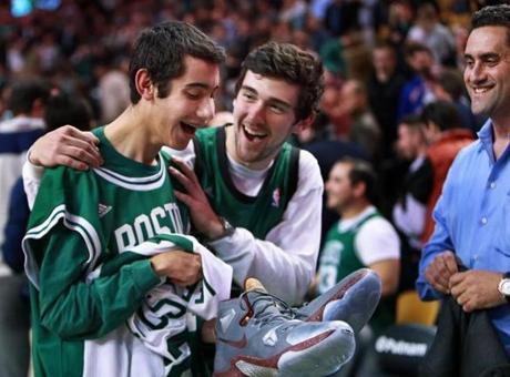 Aaron Miller (left) had in his hand the Nike sneakers Cavaliers star LeBron James wore against the Celtics Tuesday night. 
