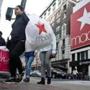 Shoppers carry bags as they cross a pedestrian walkway near Macy's in Herald Square in New York in November.