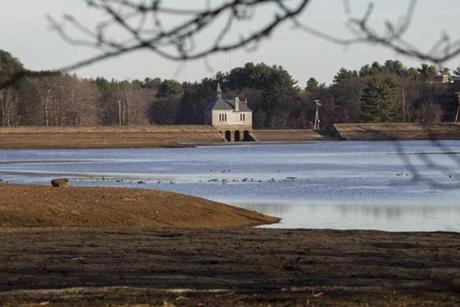 The Foss Reservoir in Framingham was recently lowered by 10 feet to combat invasive aquatic plants.
