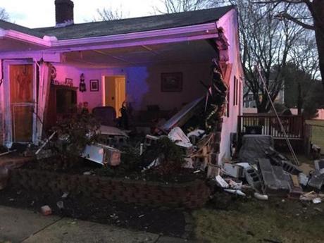 Damage to a house in Foxborough after a car crashed into the building Friday morning.
