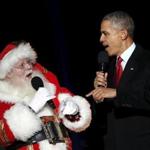 U.S. President Barack Obama and a man dressed as Santa Claus sang onstage during the National Christmas Tree Lighting and Pageant of Peace ceremony on the Ellipse in Washington. 