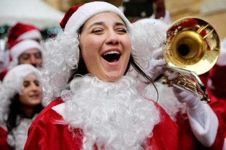  A Lebanese woman wearing a Santa Claus costume sings during a Christmas event, in downtown Beirut on Dec. 19. (Hussein Malla/Associated Press)
