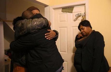 Melvin Jones (facing camera) and Robin Andrews, brothers of victim Bettie Jones, hugged in Jones?s home Saturday.
