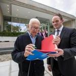 Artist Ellsworth Kelly (left) signed a book with museum director Christopher Bedford during an event at Brandeis University's Rose Art Museum.