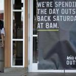 A man looked into the window of an REI store that was closed on Black Friday. 