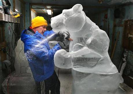 Steve Rose worked on a polar bear inside a studio freezer in Rockland. The temperature was 16 degrees and the polar bear was made from seven, 300-pound blocks of ice. It will be transported early Wednesday to Copley Square for the First Night festivities.
