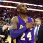 Los Angeles Lakers' Kobe Bryant touches his chestt as he walks of the court in Boston after the Lakers' 112-104 win over the Boston Celtics in an NBA basketball game Wednesday, Dec. 30, 2015.(AP Photo/Winslow Townson)