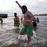 Swimmers ran out of Dorchester Bay during the annual L Street Brownies New Year's Day Swim in South Boston. 