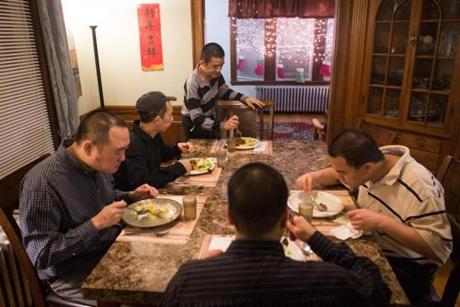 (Clockwise from right to left)- Residents Wayne Wang, Francis Chan, Wei -Li Sun, Joseph Wong, and Donald Lee eat their meal together at the group home. 
