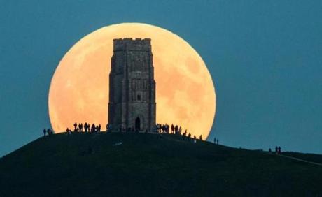 The supermoon rises behind Glastonbury Tor on Sept. 27 in Glastonbury, England. Tonight?s supermoon, so called because it is the closest full moon to the Earth this year, is particularly rare as it coincides with a lunar eclipse, a combination that has not happened since 1982 and won?t happen again until 2033. (Matt Cardy/Getty Images) 

