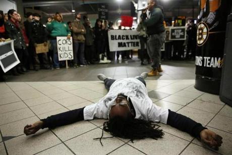 Demetrius Burns laid on the ground while playing the part of Tamir Rice during an interpretive dance at the Black Lives Matter rally at the TD Garden. 
