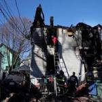 Firefighters continued to work at the scene of a fatal house fire in Lynn, MA on Christmas eve. 