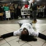Demetrius Burns laid on the ground while playing the part of Tamir Rice during an interpretive dance at the Black Lives Matter rally at the TD Garden. 