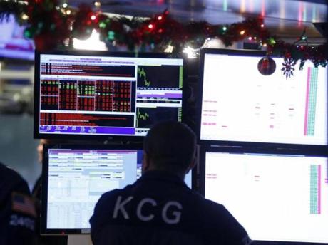A trader worked on the floor of the New York Stock Exchange on Monday. The Dow Jones Industrial Average opened the new year with a sharp drop after a plunge in China and declines in Europe.
