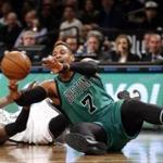 Boston Celtics center Jared Sullinger (7) passes from the floor after tangling with Brooklyn Nets forward Willie Reed (33) in the first half of an NBA basketball game, Monday, Jan. 4, 2016, in New York. (AP Photo/Kathy Willens)