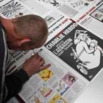 A printer checked a copy of the French newspaper Charlie Hebdo, which was attacked by terrorists last year. ?One year on, the assassin still on the run,? the headline proclaims. 
