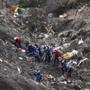 Investigators worked at the site of scattered debris after a Germanwings Airbus A320 crashed in the French Alps. 