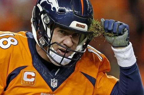 Denver Broncos quarterback Peyton Manning pulls grass off his helmet during the second half in an NFL football game against the San Diego Chargers, Sunday, Jan. 3, 2016, in Denver. (AP Photo/David Zalubowski)
