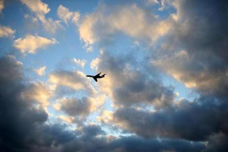 The sun broke through the clouds as a jet headed to Logan Airport over South Boston Friday morning. 
