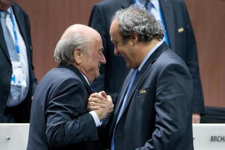 Sepp Blatter (left) shook hands with  Michel Platini during the 65th FIFA Congress at Hallenstadion in Zurich, Switzerland. 
