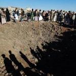 Yemenis gather around a crater reportedly caused by a Saudi-led airstrike targeting the outskirts of the capital Sanaa on Dec. 29.