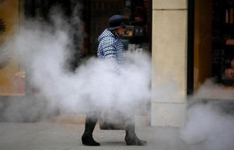 A pedestrian didn?t seem to mind the steam from the street as she walked along Boylston Street Friday morning. 

