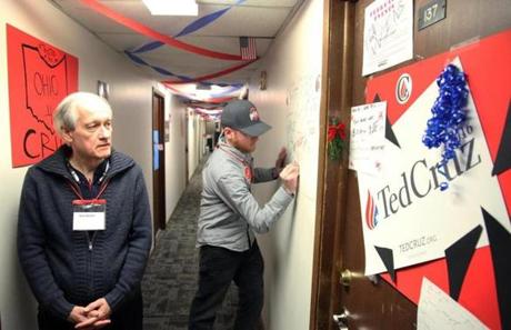 Organizer Ken Brolin looked at door decorations as volunteer Jerry Dunleavy, of Columbus, Ohio, signed a poster in the hallway at ?Camp Cruz?earlier this month.
