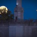 A full moon makes rises next the Springfield Memorial Bridge in downtown Springfield, Massachusetts. The bridge was constructed in 1922 and spans 209 feet. (Steven G Smith for The Boston Globe)