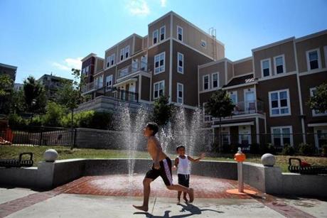 Children played in a fountain in the Box District, a newly redeveloped area near Bellingham Square in Chelsea.
