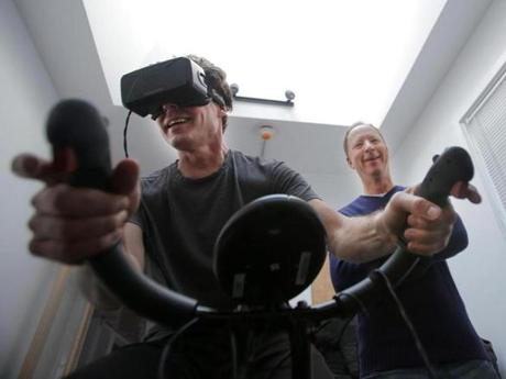 The author tried out a virtual workout with guidance from VirZOOM?s Eric Janszen (center) and Eric Malafeew.
