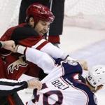 Arizona Coyotes' John Scott, left, punches Columbus Blue Jackets' Jared Boll (40) during a fight in the second period of an NHL hockey game Thursday, Dec. 17, 2015, in Glendale, Ariz. (AP Photo/Ross D. Franklin)