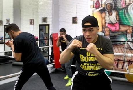 Lawrence, MA: 01-05-2016: Jesus Flores (left) loosens up before training session at the Canal Street Boxing Gym inn Lawrence, Mass. January 5, 2016. He, and Yamarco Guzman (left) and Xavier Verga (center, rear) training for an upcoming Golden Gloves boxing competition. Photo/John Blanding, Boston Globe staff story/Steven Rosenberg, NOWK ( 24nogoldengloves )
