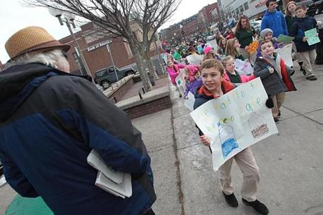 Liam Bell and fellow Saint Peter Academy students made their way down West Broadway to educate people about the situation in Flint, Mich.
