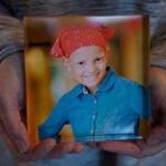 Paula Skelley displays a photograph of her daughter Lydia Valdez, seen here at age 8, who died a year later, in 2013.
