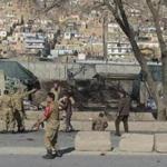 Afghan security personnel gathered as victims were treated Monday at the site of a suicide car bombing next to a police base in Kabul.