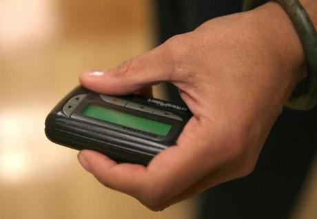 Yvette Hall-Swain, a nurse manager in emergency services at South Shore Hospital in Weymouth, held a pager. About 85 percent of hospitals still rely on the devices, analysts said.
