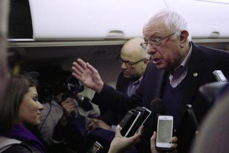 Bernie Sanders spoke to reporters early Tuesday aboard his campaign plane, which was bound for New Hampshire.

