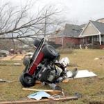 A riding lawn mower lay on the ground after a strong storm passed through Collinsville, Miss., on Tuesday.