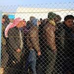 Syrians fleeing the conflicts in Azaz region, queue at the Bab al-Salam border gate on Friday.