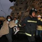 TOPSHOT - Rescue personnel carry a survivor at the site of a collapsed building in the southern Taiwanese city of Tainan following a strong 6.4-magnitude earthquake that struck the island early on February 6, 2016. At least 30 people have been rescued after four buildings collapsed after a shallow quake struck at a depth of 10 kilometres (six miles) around 2000 GMT Friday, according to the US Geological Survey, 39 kilometres northeast of Kaohsiung, the second-largest city on the island and an important port. / AFP / Johnson LiuJOHNSON LIU/AFP/Getty Images